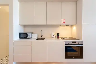 a bathroom with a sink and a toilet and a shower at São Bento Bright Studio in Porto
