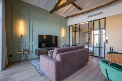 a living room with a couch and a tv at Riverside Oasis by LovelyStay in Vila Nova de Gaia