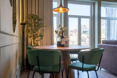 a table and chairs in a room with a window at Riverside Oasis by LovelyStay in Vila Nova de Gaia