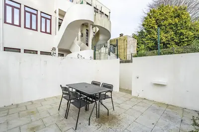 a table and chairs on a patio in front of a building at Nomad's Family - 3BDR Charming Hideouts Porto in Porto