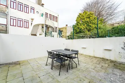 a table and chairs sitting on a patio at Nomad's Family - 3BDR Charming Hideouts Porto in Porto
