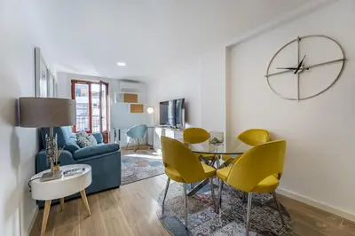 a living room with a blue couch and yellow chairs at Nomad's Lux - 1BDR The Silent Nest in Bonfim in Porto