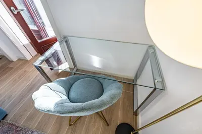 a glass table and a chair under a glass table at Nomad's Lux - 1BDR The Silent Nest in Bonfim in Porto
