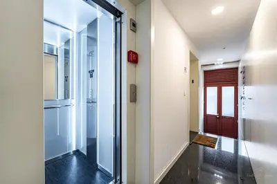 a hallway with a glass door leading to a hallway with a red door at Nomad's Lux - 1BDR The Silent Nest in Bonfim in Porto