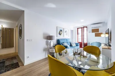 a living room with a glass table and yellow chairs at Nomad's Lux - 1BDR The Silent Nest in Bonfim in Porto