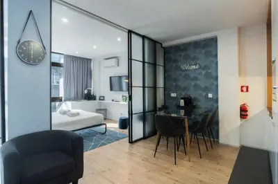 a apartment with a dining room and a bedroom at GuestReady - Oporto Blue Douro Residence in Porto