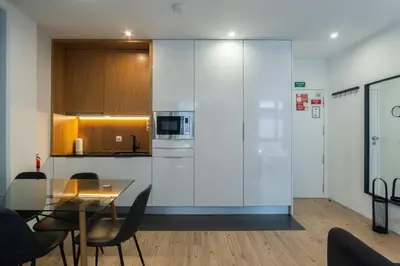 a kitchen and dining room with a glass table at GuestReady - Oporto Blue Douro Residence in Porto