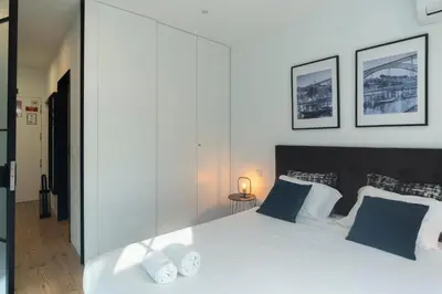 a bedroom with a large white bed with blue pillows at GuestReady - Oporto Blue Douro Residence in Porto
