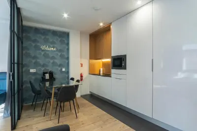 a kitchen and dining room with a table and chairs at GuestReady - Oporto Blue Douro Residence in Porto