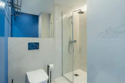 a bathroom with a shower and a toilet at GuestReady - Oporto Blue Douro Residence in Porto