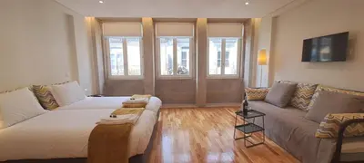 a living room with a white couch and a couch at ALMARELA apartments in Porto