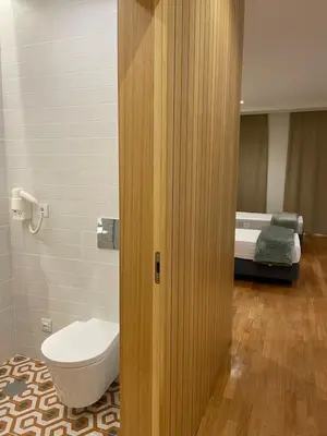 a bathroom with a toilet and a bed in a room at ALMARELA apartments in Porto