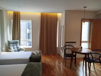 a hotel room with a bed and a table at ALMARELA apartments in Porto