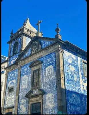 a blue and white building with a cross on top at Porto Bello - Apartamento -1 in Porto