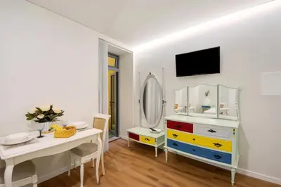 a white room with a dressing table and a mirror at Porto Bello - Apartamento - 2 in Porto