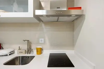 a kitchen with a sink and a counter top at Porto Bello - Apartamento - 2 in Porto