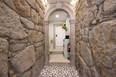 a hallway of a house with a stone wall at Porto Bello - Apartamento - 2 in Porto