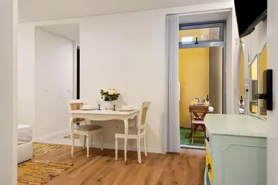 a kitchen and dining room with a table and chairs at Porto Bello - Apartamento - 2 in Porto