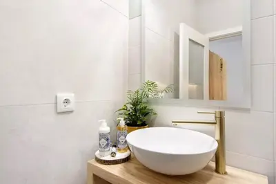 a bathroom with a white sink and a mirror at Porto Bello - Apartamento - 3 in Porto