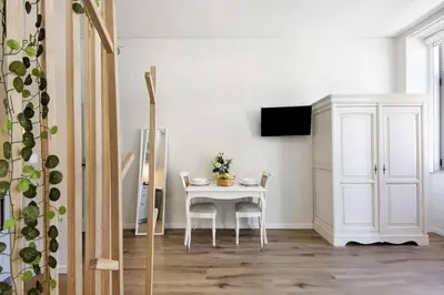 a dining room with a white table and chairs at Porto Bello - Apartamento - 3 in Porto