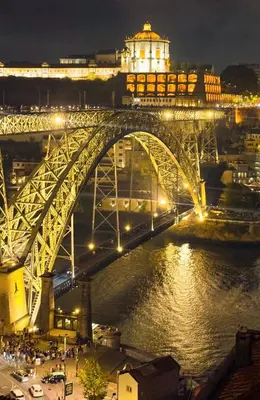 a bridge over a river with a city at night at Porto Bello - Apartamento - 4 in Porto