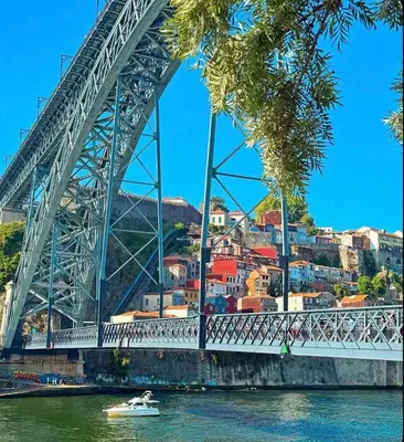 a boat in the water under a bridge at Porto Bello - Apartamento - 4 in Porto
