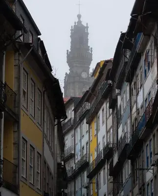 a group of buildings with a clock tower in the background at Porto Bello - Apartamento - 4 in Porto