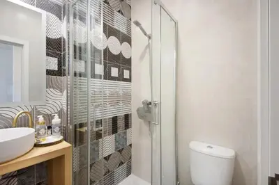 a bathroom with a shower and a toilet and a sink at Porto Bello - Apartamento - 5 in Porto