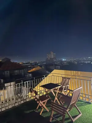 two chairs and a table on a balcony at night at Porto Bello - Apartamento - 5 in Porto