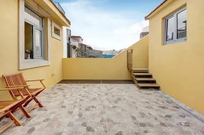 a balcony with two chairs and two windows at Porto Bello - Apartamento - 8 in Porto