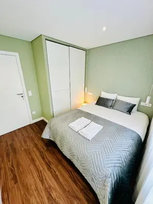 a bedroom with a bed with two towels on it at House Real Companhia 55/53 in Vila Nova de Gaia