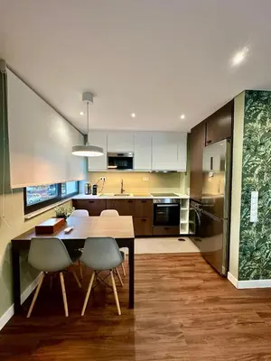 a kitchen with a wooden table and chairs at House Real Companhia 55/53 in Vila Nova de Gaia