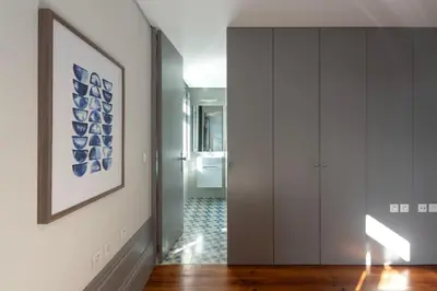 a living room with a dining room table and chairs at Cedofeita's Blue House in Porto