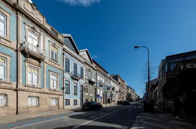 a bedroom with two beds with pillows at Cedofeita's Blue House in Porto