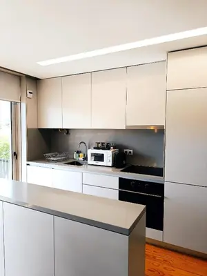 a kitchen with white cabinets and a microwave at BO - Aníbal Cunha in Porto