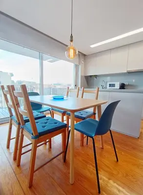 a kitchen and dining room with a table and chairs at BO - Aníbal Cunha in Porto