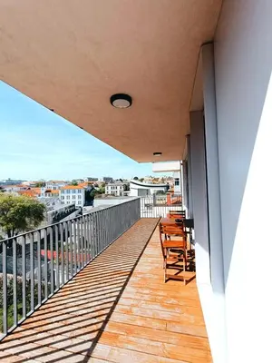 a balcony with chairs and a view of a city at BO - Aníbal Cunha in Porto
