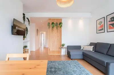 a living room with a couch and a table at Host Wise - Spacious Modern Flat w Balcony in Porto