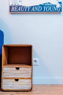 a wooden box sitting on the floor next to a wall at Emotions Trindade Flat in Porto