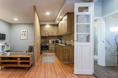 a kitchen with a door open to a living room at Experience the Charm Porto Apartment with Terrace in Porto