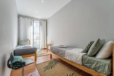 a bedroom with a bed and a couch and a window at Experience the Charm Porto Apartment with Terrace in Porto
