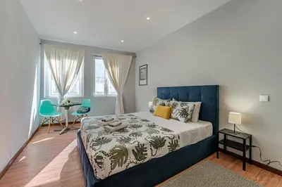 a bedroom with a bed and a table with chairs at Experience the Charm Porto Apartment with Terrace in Porto