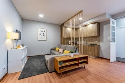 a living room with a couch and a table at Experience the Charm Porto Apartment with Terrace in Porto