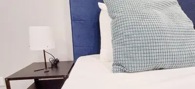 a bed with a table with a lamp next to a bed at Experience the Charm Porto Apartment with Terrace in Porto