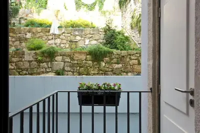 a balcony with a planter with flowers on it at Flower 45 Suite @ Rua das Flores in Porto