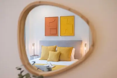 a bedroom with a bed with paintings on the wall at Golden Factory Apartment Downtown, Terrace and AC in Porto