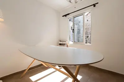a kitchen with a white table and a refrigerator at Taipas Guest House in Porto
