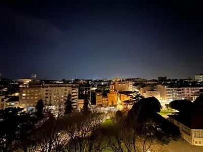 a view of a city at night with buildings at GuestReady - Central Park in Porto in Porto