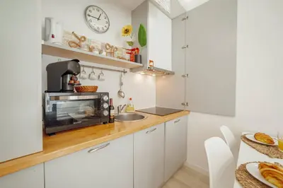 a kitchen with a sink and a microwave on a counter at Santa Catarina Apartment by Hosty in Porto