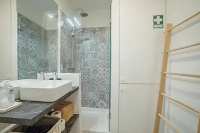 a bathroom with a sink and a shower at Santa Catarina Apartment by Hosty in Porto